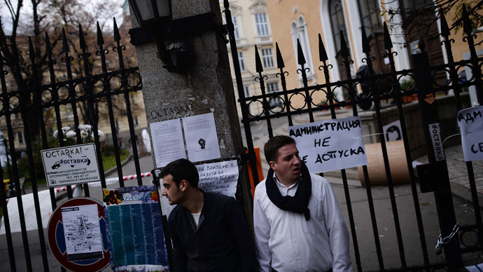 Students stand next a closed entrance of Sofia's university on November 11, 2013. (AFP Photo/Dmitar Dilkoff)