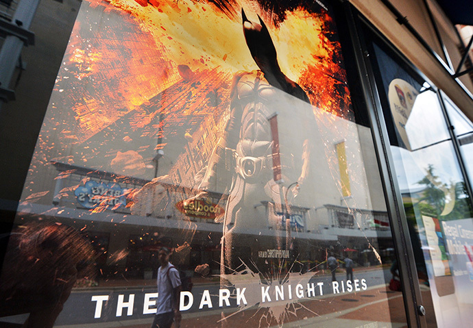 People walk past a poster of the new Batman movie "The Dark Knight Rises" outside a theater in Silver Spring, Maryland (AFP Photo / Jewel Samad)