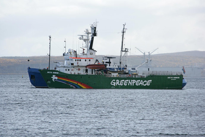 A handout photo provided by Greenpeace International shows the Greenpeace ship, Arctic Sunrise, being towed on September 24, 2013 into the Russian port of Murmansk by a Russian Coast Guard vessel. (AFP/Greenpeace International)