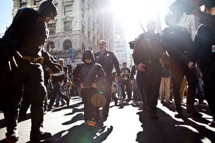 Police escorts leukemia survivor Miles, 5, dressed as BatKid, and Batman after they arrest the Riddler as part of a Make-A-Wish foundation fulfillment November 15, 2013 in San Francisco.(AFP Photo / Ramin Talaie)