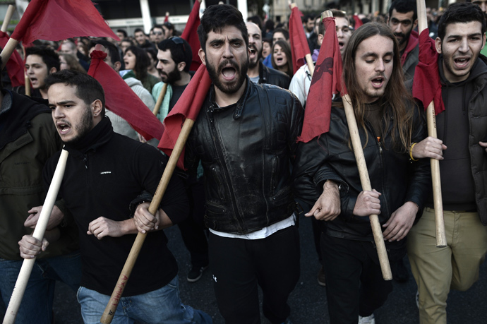 Protesters shout slogans on November 17, 2013 in the center of Athens during a march commemorating the 1973 students uprising against the military junta. Tens of thousands marched in Greece on November 17 (AFP Photo / Aris Messinis) 