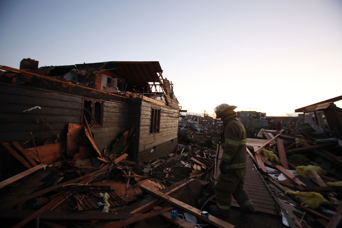 A firefighter searches through debris after a tornado struck on November 17, 2013 in Washington, Illinois. (Tasos Katopodis / Getty Images / AFP) 
