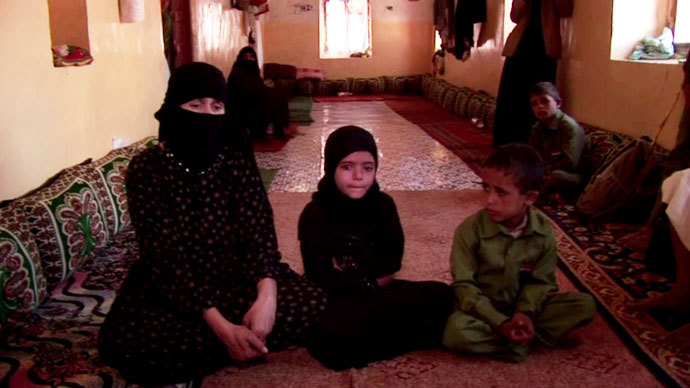 Um Salim al-Qawli, the mother of 20-year old Salim, sits with Aliâs three children. They grieve for her son and their father. Screenshot from RT video