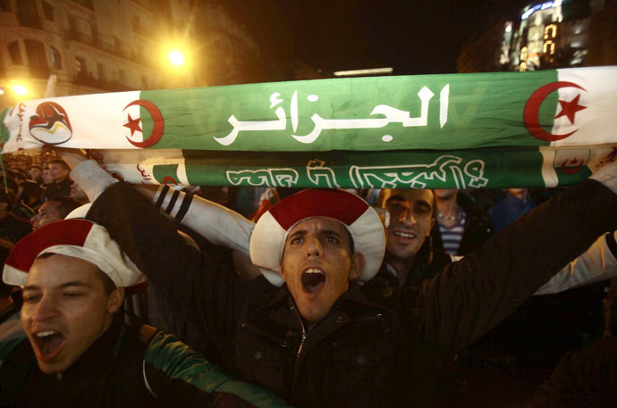 Fans of Algeria's soccer team celebrate in downtown Algiers after their team defeated Burkina Faso in their 2014 World Cup qualifying second leg playoff soccer match, November 19, 2013. (Reuters/Ramzi Boudina)