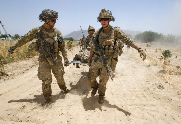U.S. Army soldiers carry Sgt. Matt Krumwiede, who was wounded by an improvised explosive device (IED), towards a Blackhawk Medevac helicopter in southern Afghanistan (Reuters / Shamil Zhumatov)