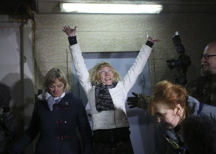 Sini Saarela of Finland (C) reacts after she was released from prison in St. Petersburg November 21, 2013. (Reuters/Alexander Demianchuk)