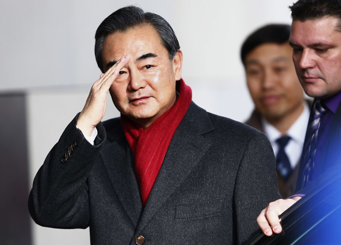 Chinese Minister of Foreign Affairs Wang Yi waves on his arrival at the Intercontinental hotel where talks are being held in Geneva November 23, 2013. (Reuters/Denis Balibouse)