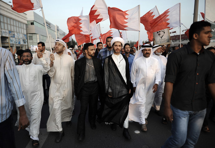 Bahrain's Al-Wefaq opposition group leader Sheikh Ali Salman (C) takes part in an anti-government protest in the village of Bilad al-Qadeem, in a suburb of the capital Manama, on November 22, 2013. (AFP Photo/Mohammed Al-Shaikh)
