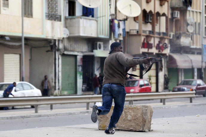 A resident, in support of the Libyan army, fires a weapon towards members of Islamist militant group Ansar al-Sharia during clashes between the group and a Libyan army special forces unit in the Ras Obeida area in Benghazi November 25, 2013. (Reuters/Esam Omran Al-Fetori)