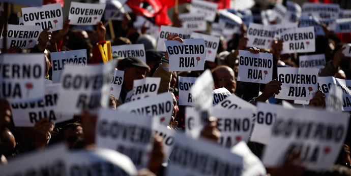 Members of CGTP-Intersindical workers union hold banners during a protest in front of Portuguese parliament in Lisbon November 26, 2013.(Reuters / Rafael Marchante)