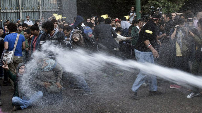 Egyptian policemen use a water canon to disperse protesters during a demonstration in downtown Cairo on November 26, 2013 against the new law passed the previous day regulating demonstrations. (AFP Photo / Khaled Desouki)