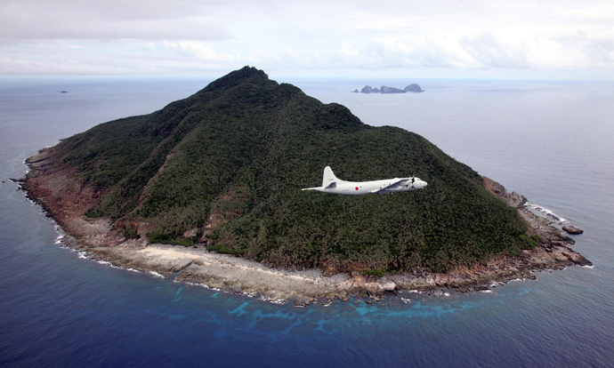 P-3C patrol plane of Japanese Maritime Self-Defense Force flying over the disputed islets known as the Senkaku islands in Japan and Diaoyu islands in China, in the East China Sea. (AFP Photo / Japan Pool via JIJI Press Japan out) 