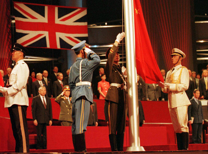 Members of the combined Chinese Armed Forces raise the Chinese Flag at the Hong Kong convention center on July 1, 1997 marking the moment Hong Kong reverted to Chinese rule. (AFP Photo/Kimimasa Mayama)