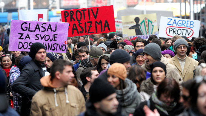 Croatian gay rights supporters hold signs reading "Against fascism" and "Vote against" as they gather for a protest outside the parliament building in Saint Marko Square in Zagreb on November 30, 2013.(AFP Photo / STR)