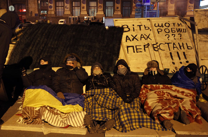 Protesters rest at a barricade at Independence Square in Kiev December 3, 2013. (Reuters//Vasily Fedosenko)