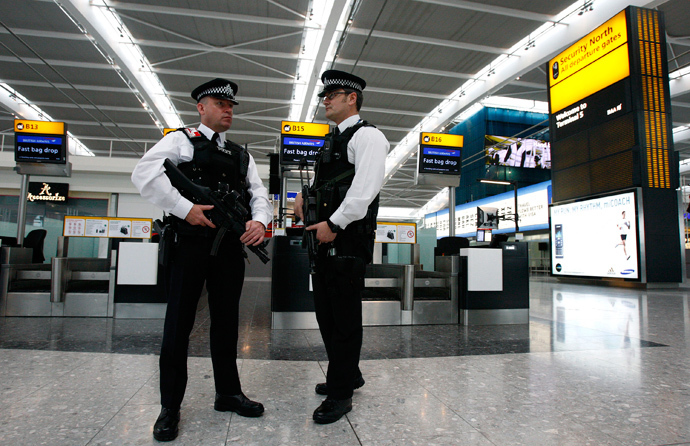 Police officers patrol the check-in hall in the new Terminal 5 building at London's Heathrow Airport (Reuters / Alessia Pierdomenico)