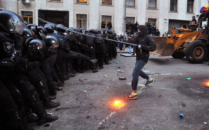 A protester with a chain clashes with police during the storming of the Viktor Yanukovych Presidential office in Kiev during a mass rally of the opposition in Kiev on December 1, 2013.( AFP Photo / Genya Savilov)