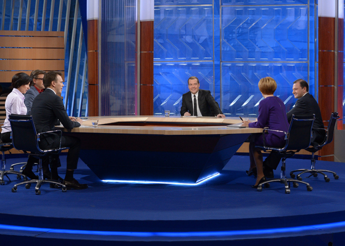 Prime Minister Dmitry Medvedev (center) gives an interview on the round-up of the Governmentâs work in 2013 to federal TV channels at the Ostankino TV Center. (RIA Novosti /Alexander Astafyev)