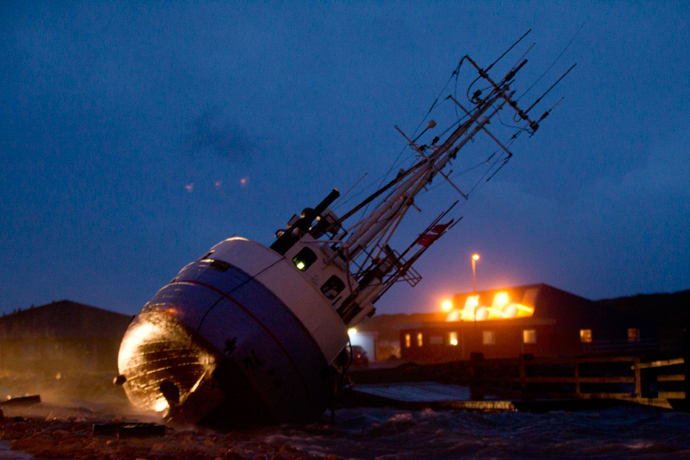 A boat lying on the side, on December 6, 2013 in Thorsminde Harbour, on the west coast iin Jutland as storm Haver hits Denmark. (AFP Photo / Scanpix Denmark / Keld Navntoft / Denmark out) 