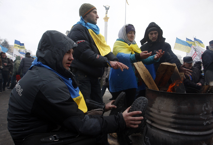 Protesters warm themselves at the camp of the opposition on Maiden (Independence) Square in Kiev on a frosty day in Kiev on December 10, 2013. (AFP Photo / Yuriy Kirnichny) 