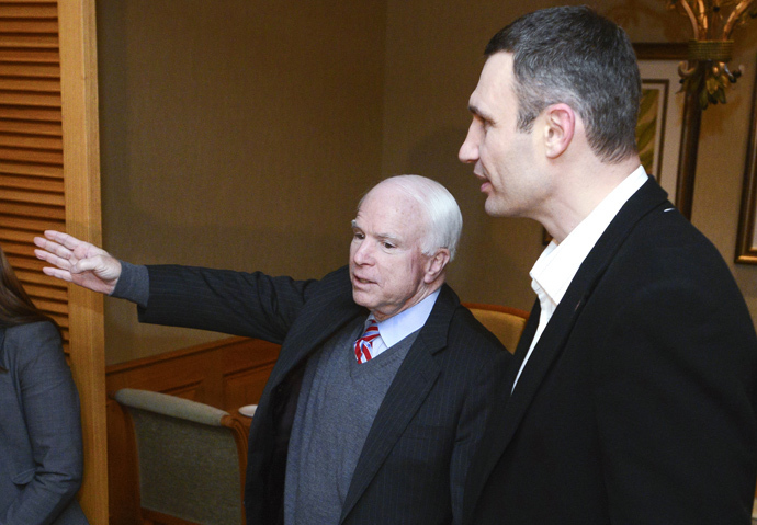 US Senator John McCain (L) gestures as he speaks to Head of UDAR (Punch) party Vitali Klitschko during a meeting with leaders of Ukrainian opposition in Kiev on December 14, 2013. McCain arrived to Ukraine over the weekend, a trip that will make him the highest-ranking US official to visit the former Soviet republic since protests erupted there last month over Kievâs move to tighten ties with Moscow. (AFP Photo / Batkivshchyna Party Press-Service Pool / Andrew Kravchenko) 