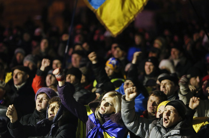 Demonstrators shout slogans during a rally held by Pro-European integration protestors in the early morning hours in central Kiev, December 17, 2013. (Reuters)