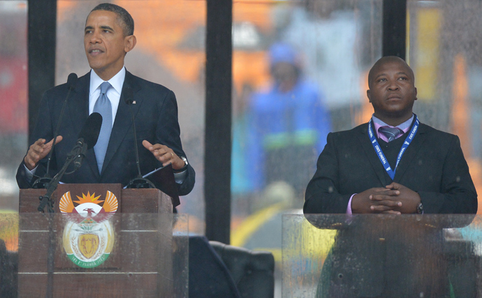 In this picture taken on December 10, 2013 US President Barack Obama delivers a speech next to a sign language interpreter (R) during the memorial service for late South African President Nelson Mandela at Soccer City Stadium in Johannesburg. (AFP Photo / Alexander Joe)