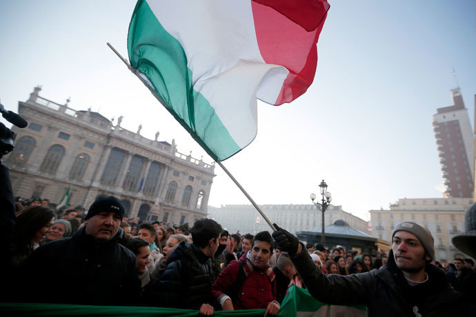 A man waves an Italian national flag during a protest against austerity measures in "Piazza Castello", in Turin on December 11, 2013. (AFP Photo / Marco Bertorello) 