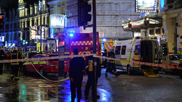 Police and emergency services personnel assist in operations behind a cordon following a ceiling collapse at a theatre in Central London on December 19, 2013.(AFP Photo / Leon Neal)