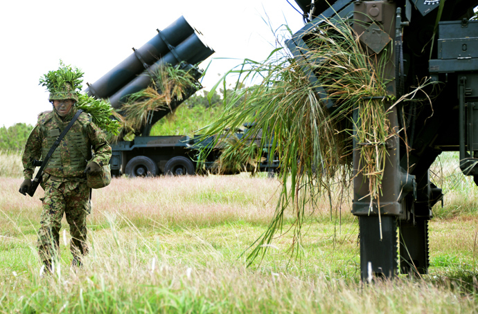 A soldier from Japan's Ground Self-Defense Force helps to prepare surface-to-ship missile launchers at Camp Naha in Naha, Okinawa Prefecture (AFP Photo / Toru Yamanaka)