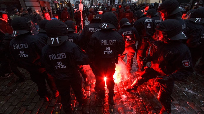German police is attacked with fireworks during clashes in front of the 'Rote Flora' cultural centre during a demonstration in Hamburg, December 21, 2013. (Reuters / Morris Mac Matzen)