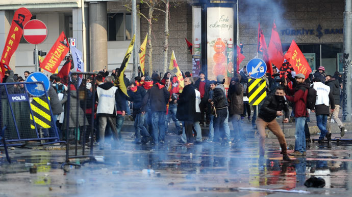 Protestors throw stones as riot police use tear gas and water cannon during a demonstration on December 22, 2013 in the Asian side of Istanbul.(AFP Photo / Ozan Kose)
