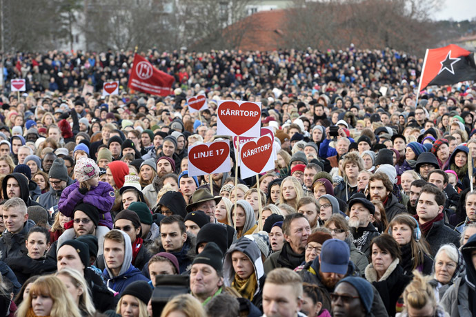 People take part in a anti rascism demonstration in Karrtop near Stockholm on December 22, 2013. (AFP/TT News Agency)