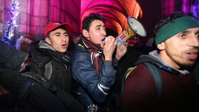 Afghan refugees shout slogans as they take part in a protest march from Brussels to Mons, organized by the 'Afghan Collective', on December 22, 2013, in Mons.( AFP Photo / Nicolas Maeterlinck)