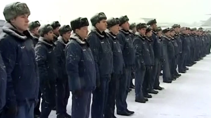 Russian transport aviation troops stand to attention during a ceremony wrapping up the operation to transport military vehicles to Syria. RT video still.