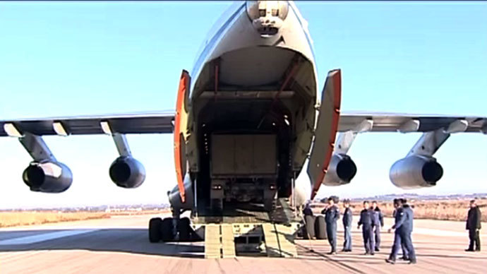 Russian military armored trucks being unloaded in Syria after an airlift. RT video still.