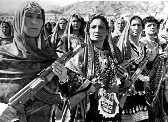 Afghan women carry Soviet AK-47's during a parade of village defense forces in 1988. (Reuters / Richard Ellis)