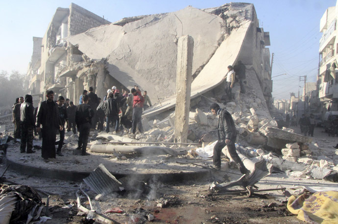 People inspect a site damaged by what activists said was an air raid by forces loyal to Syrian President Bashar Al-Assad, in Aleppo's al-Marja district December 23, 2013. (Reuters/Saad AboBrahim)