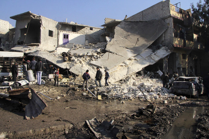 Residents inspect the damage at a site after what activists said was an air raid by forces loyal to Syrian President Bashar Al-Assad, at Masaken Hanano in Aleppo, December 22, 2013. (Reuters/Saad AboBrahim)