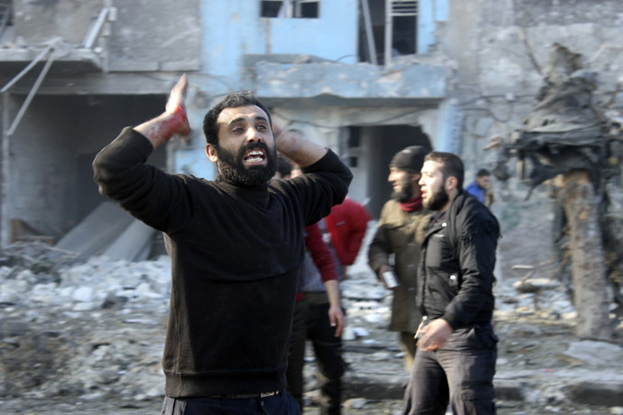 A man with blood stained hand reacts at a damaged site after what activists said was heavy shelling by forces loyal to Syrian President Bashar Al-Assad, in Masaken Hanano neighbourhood in Aleppo December 22, 2013. (Reuters/Hosam Katan)