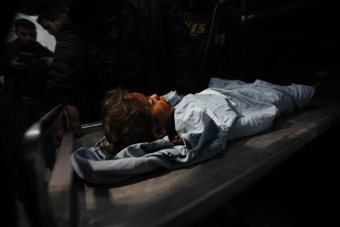 The body of three-years-old Palestinian girl Hala Bhairi, who medics said was killed by shrapnel during an Israeli air strike on the Bureij facility, lies at a hospital morgue in the central Gaza Strip December 24, 2013. (Reuters/Ibraheem Abu Mustafa)