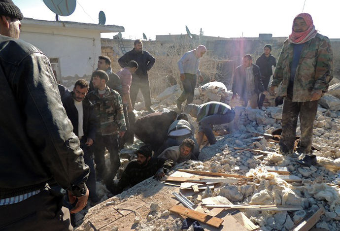 Syrians search for survivors under the rubble following airstrikes by Syrian government forces on December 22, 2013 in a residential area of the northern Syrian city of Marea on the outskirts of Aleppo. (AFP Photo / Mohammed Al-Khateib)