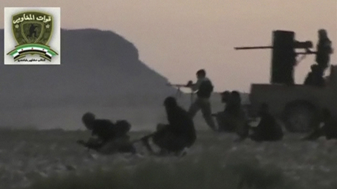 Syrian rebels from the "Maghawir of Baba Amer" and "Baba Amer Revolutionaries" brigades exchange gunfire with Syrian government forces at a checkpoint in Maaloula, a suburb of Damascus, in this image taken from a September 4, 2013 video footage obtained from a social media website. (Reuters)