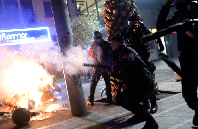 Turkish riot police fire tear gas at protestors (unseen) during a demonstration against corruption in the Kadikoy district of Istanbul on December 25, 2013 (AFP Photo / Bulent Kilic)