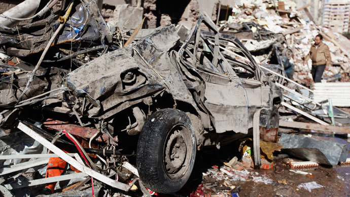 A man walks near debris after an explosion near security building in Egypt's Nile Delta city of Mansoura in Dakahlyia province, about 120 km (75 miles) northeast of Cairo December 24, 2013.(Reuters / Mohamed Abd El Ghany)