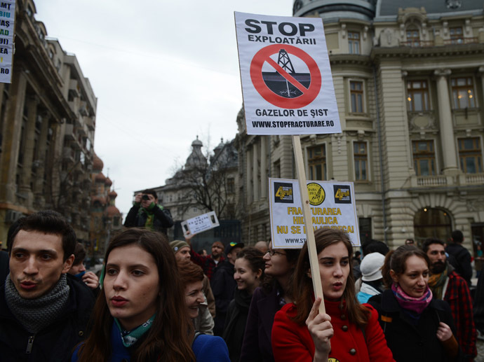 Protesters hold a poster reading "STOP shale gas expoiting" during a demonstration against hydraulic fracturing (fracking) in Bucharest April 4, 2013. (AFP Photo/Daniel Mihailescu)