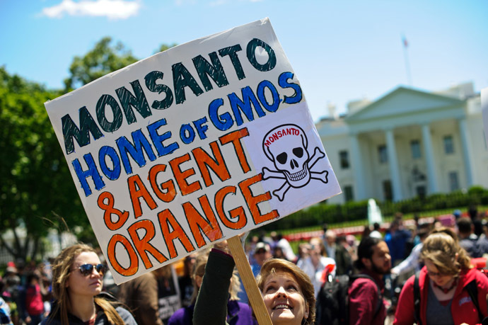 People hold signs during a demonstration against agribusiness giant Monsanto and genetically modified organisms (GMO) in front of the White House in Washington on May 25, 2013. (AFP Photo/Nicholas Kamm)