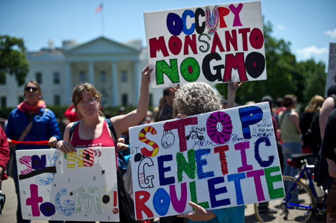 People hold signs during a demonstration against agribusiness giant Monsanto and genetically modified organisms (GMO) in front of the White House in Washington on May 25, 2013. (AFP Photo/Nicholas Kamm)