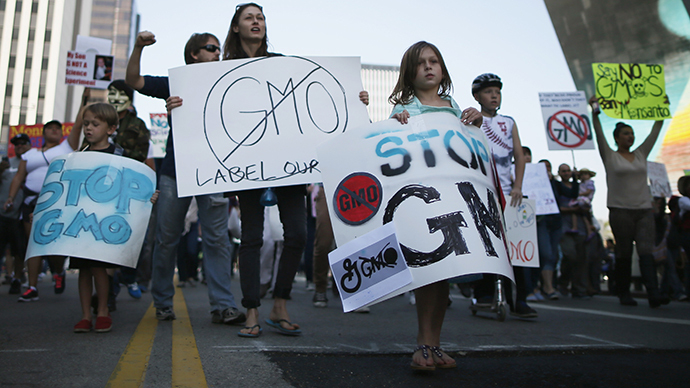 People hold signs during one of many worldwide "March Against Monsanto" protests against Genetically Modified Organisms (GMOs) and agro-chemicals, in Los Angeles, California October 12, 2013. (Reuters / Lucy Nicholson)