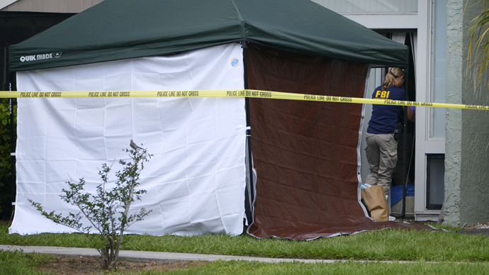 A member of the FBI enters the apartment of Ibragim Todashev, 27, in Orlando, Florida, May 22, 2013. (Reuters / Phelan Ebenehack)